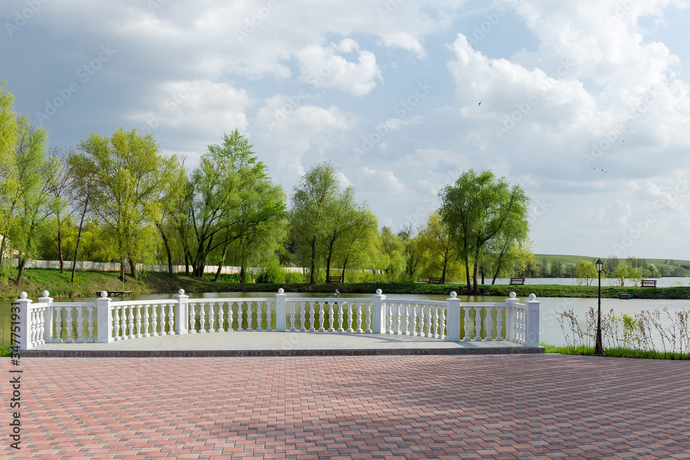 Observation deck with balustrade over pond in the park