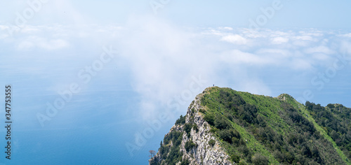 Hiker explores beautiful Capri Island, Italy on a hot summer day