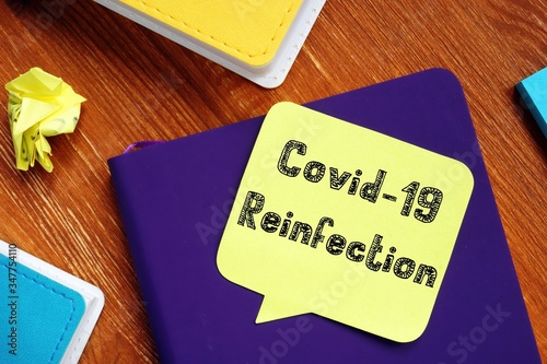 Health concept meaning covid reinfection with sign on the piece of paper. photo