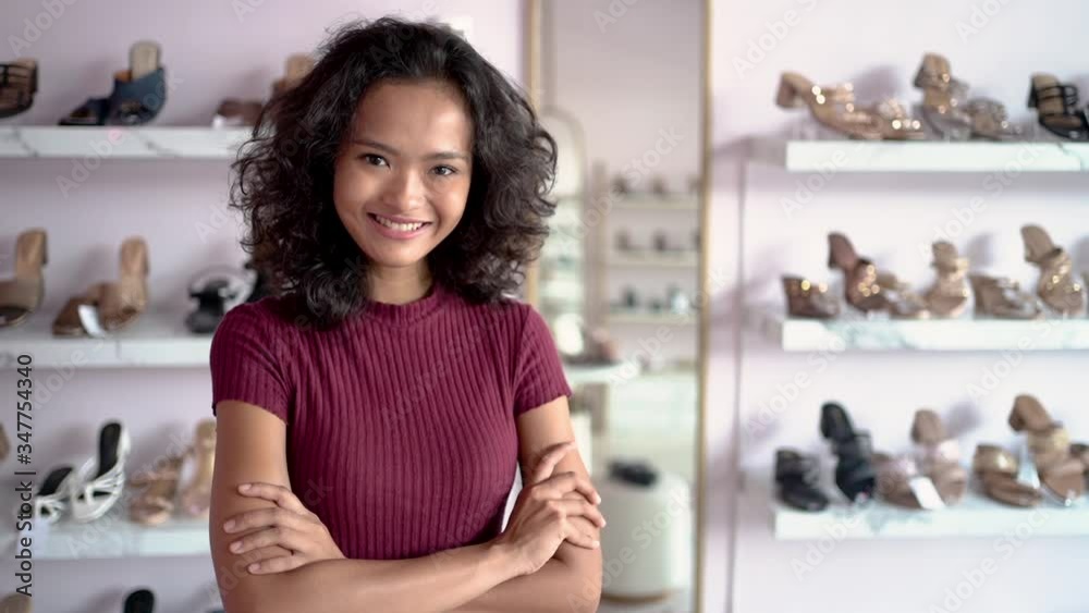beautiful young asian fashion shop owner at her boutique standing proudly and smile to camera beautiful young asian fashion shop owner at her boutique standing proudly and smile to camera