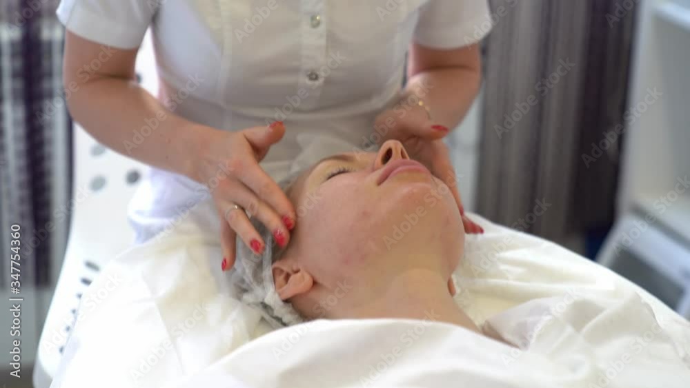 Beautician makes skin cleansing procedure for a young woman. Apply a cleansing mask. Skin hygiene Beautician makes skin cleansing procedure for a young woman. Apply a cleansing mask. Skin hygiene