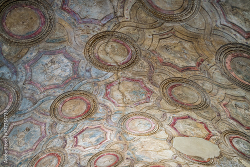 Hand sculpted and painted ceiling at the Roman baths in the ruins of Pompeii  Italy.