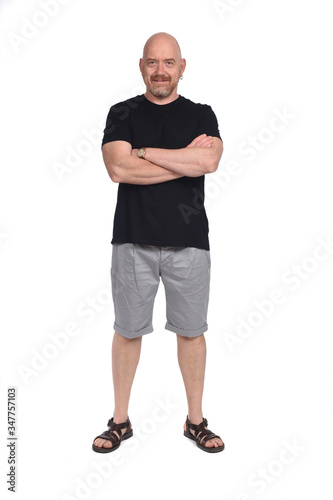 Bald man with sandals t-shirt and shorts, arms crossed