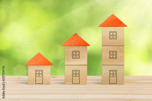 Wood block houses in a growth real estate concept.