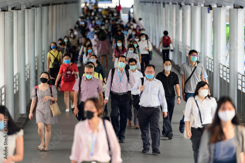 Photography Crowd of people wearing surgical mask and walking at Bangkok downtown