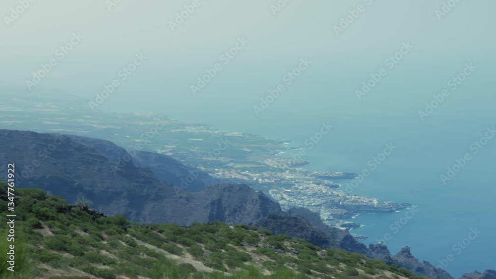 View from high up in Teno mountains to Los Gigantes with birds flying. Panning shot, wide angle view. View from high up in Teno mountains to Los Gigantes with birds flying. Panning shot, wide angle view.