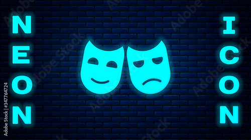 Glowing neon Comedy and tragedy theatrical masks icon isolated on brick wall background.  Vector Illustration