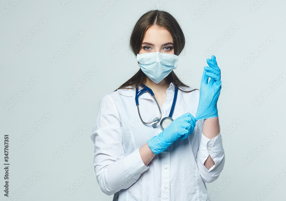 Covid19, coronavirus, a concept of healthcare and doctors. Portrait of a female doctor wearing a medical mask to prevent infection with the virus Covid19, coronavirus, a concept of healthcare and doctors. Portrait of a female doctor wearing a medical mask to prevent infection with the virus