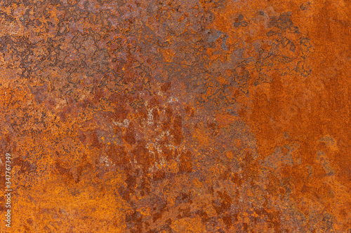 Orange textured old rusty metal surface. An weathered oxidized patina with a copper color, texture and structure. Vintage material effect
