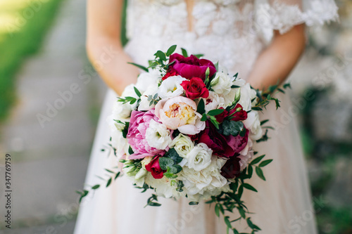 Bride in white dress holding bouquet