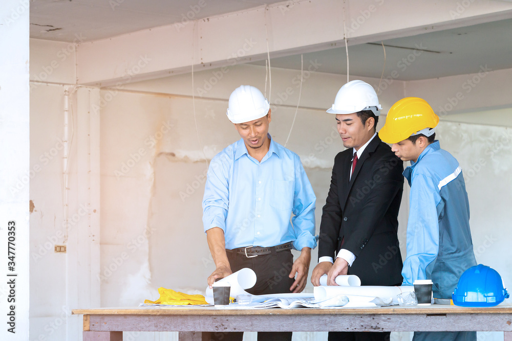 Businessman engineer and worker looking paper plans at construction site. Businessman engineer and worker looking paper plans at construction site.