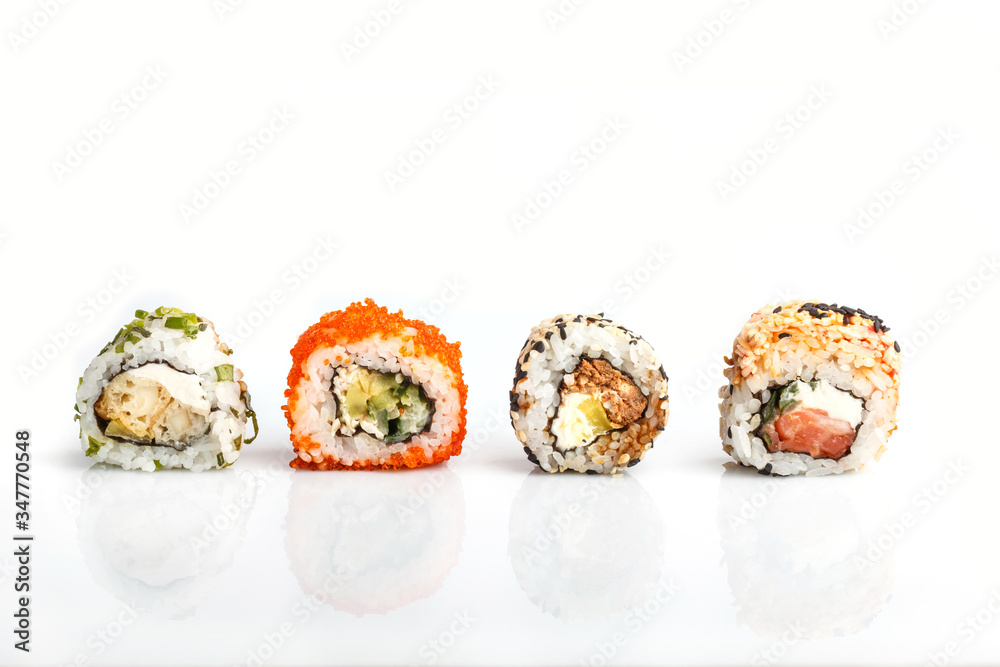 Four Japanese maki sushi rolls in a row with salmon, sesame, avocado, cheese isolated on white background. Side view Four Japanese maki sushi rolls in a row with salmon, sesame, avocado, cheese isolated on white background. Side view