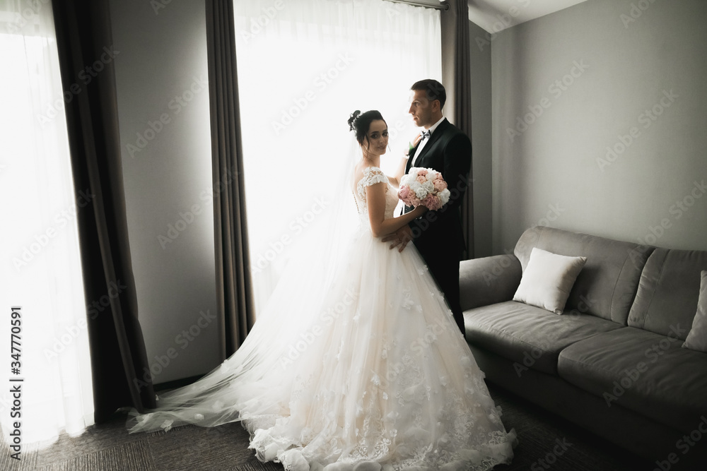 Wedding couple on the nature is hugging each other. Beautiful model girl in white dress. Man in suit Wedding couple on the nature is hugging each other. Beautiful model girl in white dress. Man in suit