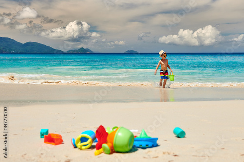 Fototapeta Naklejka Na Ścianę i Meble -  Three year old toddler playing on beach
