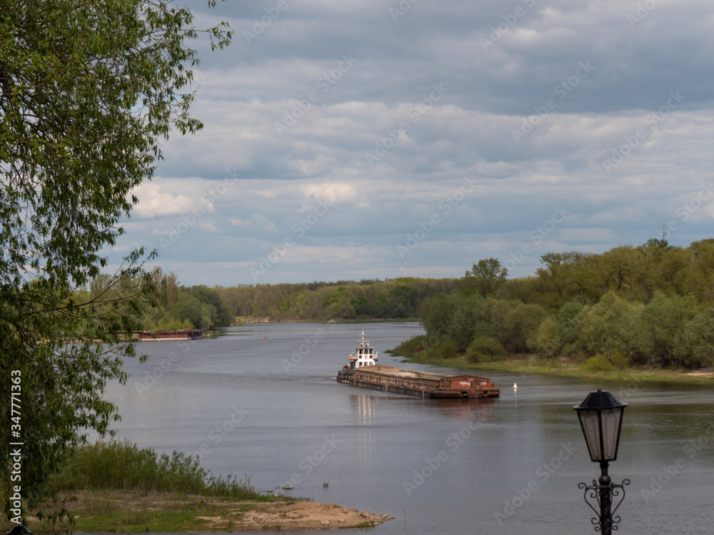barge goes on the river in spring