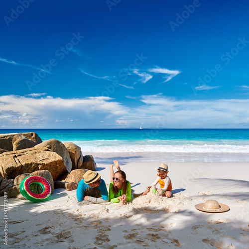 Fototapeta Naklejka Na Ścianę i Meble -  Family with three year old boy on beach