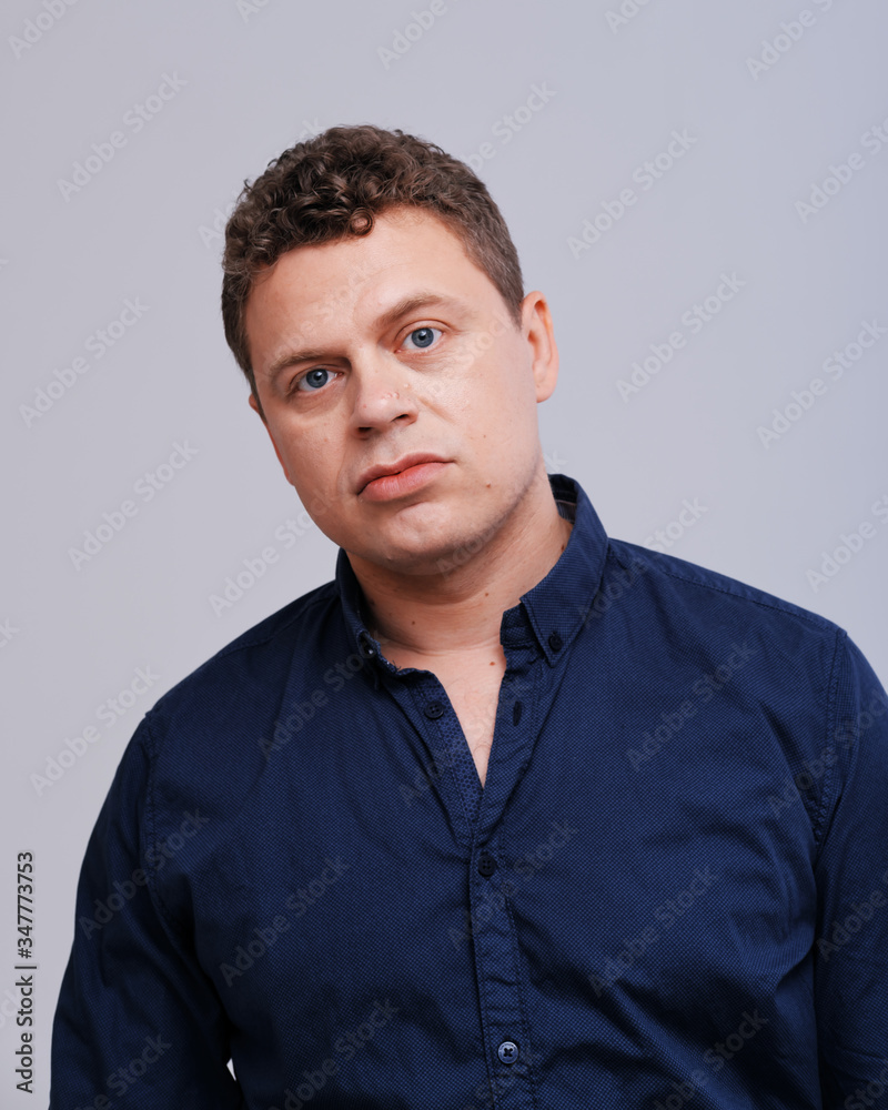 Studio portrait of man with hand on head Studio portrait of man with hand on head