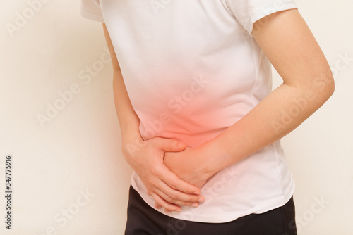 Wallpaper Mural Young woman suffering from stomach ache on gray background Torontodigital.ca