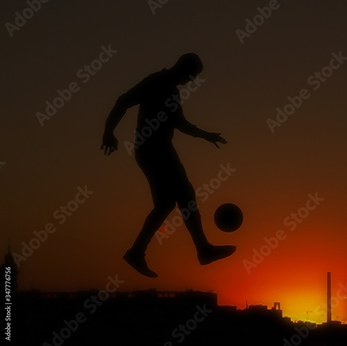one man soccer player playing with ball during sunset silhouette © victoria chaikova