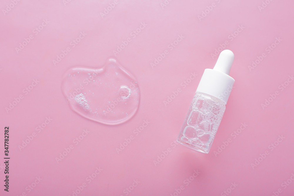 Anti aging serum in glass bottle with dropper on pink background. Facial liquid serum with collagen and peptides. Anti aging serum in glass bottle with dropper on pink background. Facial liquid serum with collagen and peptides.