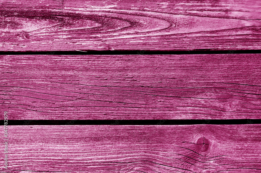 Old grungy wooden planks background in pink tone.