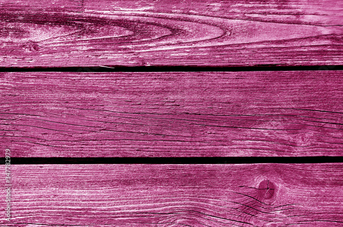 Old grungy wooden planks background in pink tone.