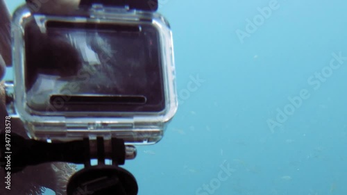 setting up gopro action camera for underwater shot; pov