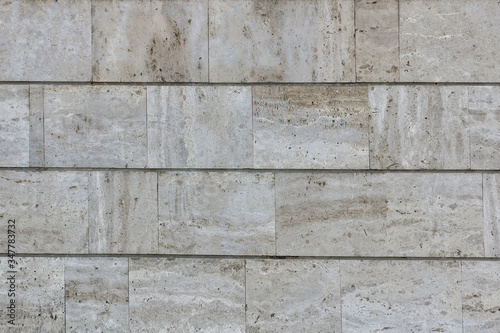 Marble beige tile wall covering. Building facade. Marble background texture