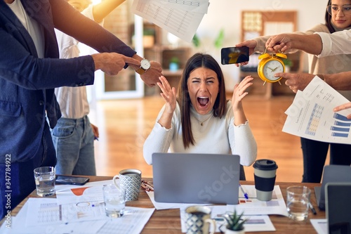 Group of business workers working together. Partners stressing one of them at the office