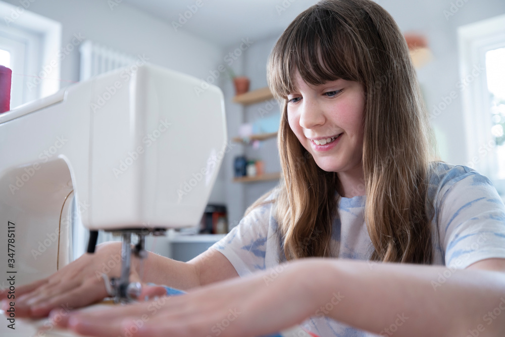 Young Girl Learning How To Use Sewing Machine At Home Young Girl Learning How To Use Sewing Machine At Home