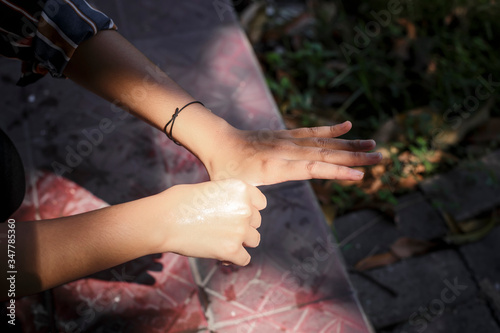 Girl washing hands with waterunder the sunlight. Hygiene concept hand detail. © Mohammad