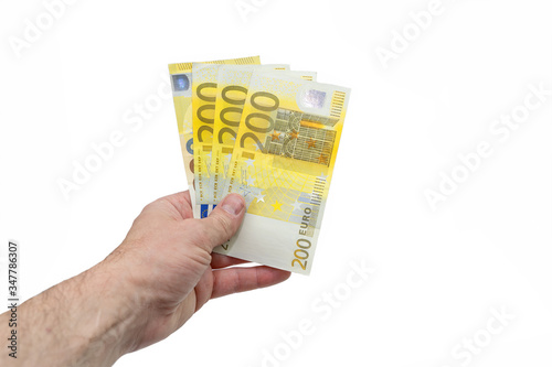 A fan of 200 two hundred euros. The hand of a European man holds a fan of European money. Isolated white background. Close-up.