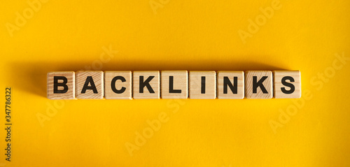 Backlinks word cube on a yellow background. Seo concept. photo
