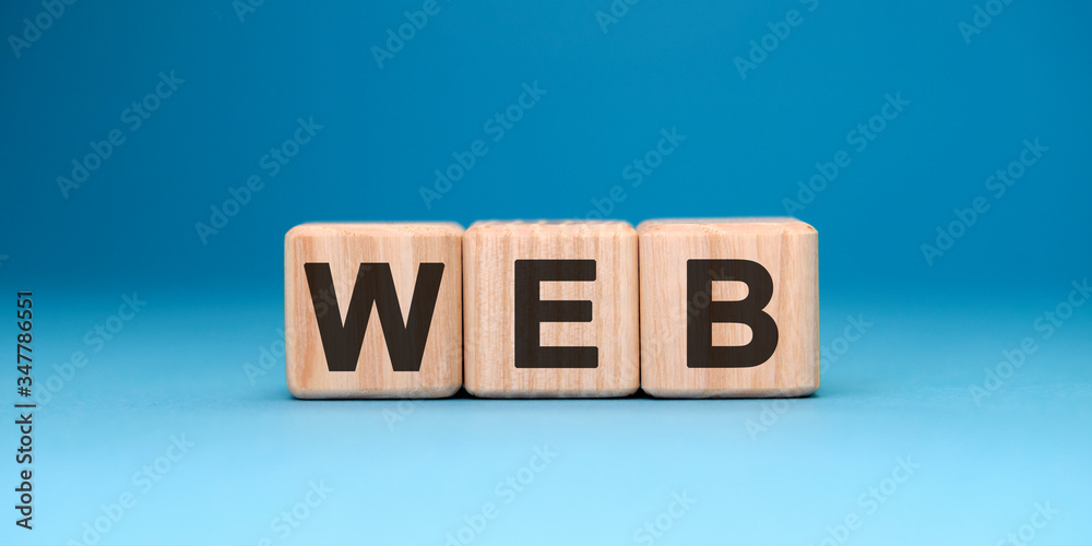WEB website - text concept on wooden cubes with gradient blue background WEB website - text concept on wooden cubes with gradient blue background