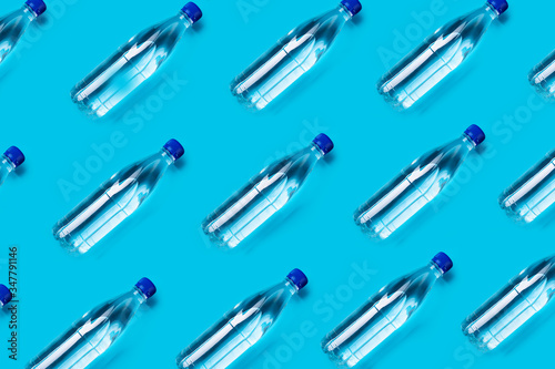 many plastic water bottles on a blue background shot from above