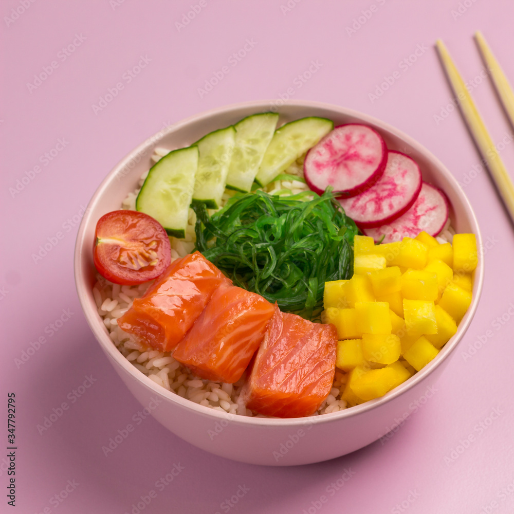 Traditiona Hawaiian red fish poke bowl with rice, radish,cucumber, tomato, and seaweeds. Buddha bowl. Diet food. Flat lay. Traditiona Hawaiian red fish poke bowl with rice, radish,cucumber, tomato, and seaweeds. Buddha bowl. Diet food. Flat lay.