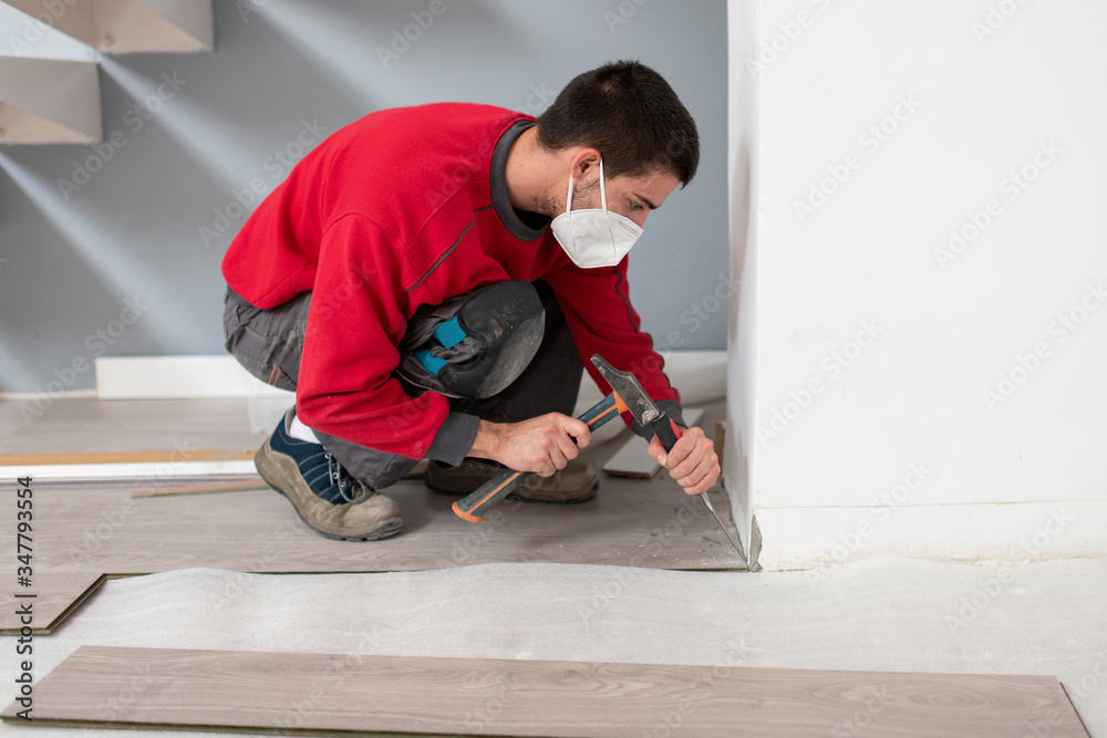 repairman laying flooring repairman laying flooring