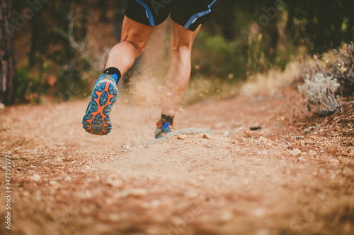 Trail running. Closeup of running shoes in action. Copy space