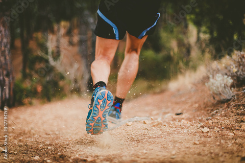 Trail running. Closeup of running shoes in action. Copy space