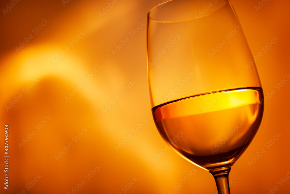 Glass of glowing golden white wine in close up Glass of glowing golden white wine in close up