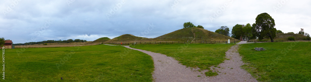 Panoramic view of Gamla Uppsala. The three large royal mounds. According to ancient mythology and folklore, the three gods Thor, Odin and Freyr. Sweden.