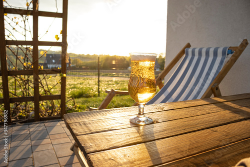 Canvastavla Glass of beer at the table on patio