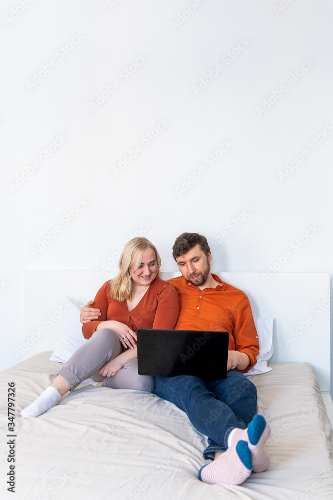 Young adult couple using laptop together at home Young adult couple using laptop together at home
