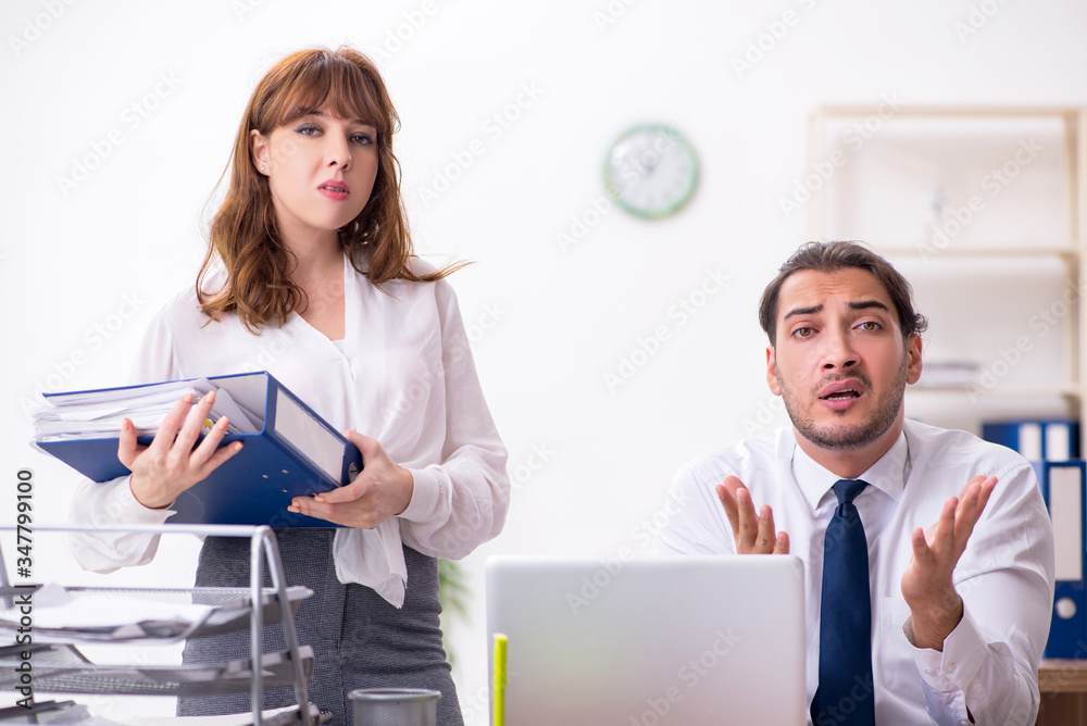 Two employees working in the office Two employees working in the office