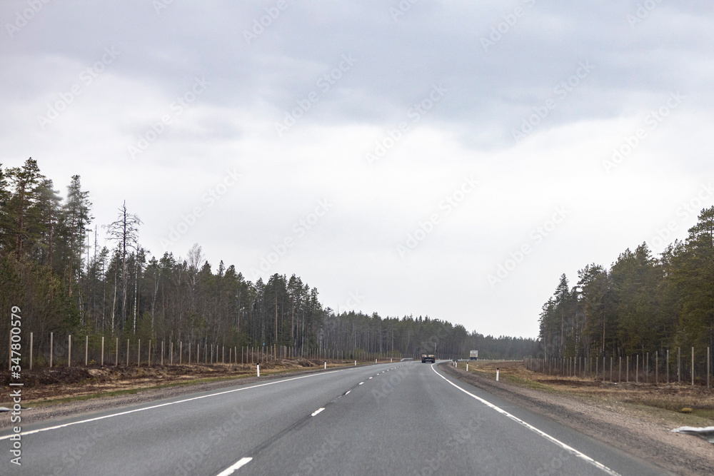 road with white dividing strip on the background of beautiful sky with clouds road with white dividing strip on the background of beautiful sky with clouds