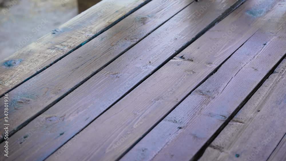 Restoration work with an old tree. Painting the boards with brown impregnation. Restoration work with an old tree. Painting the boards with brown impregnation.