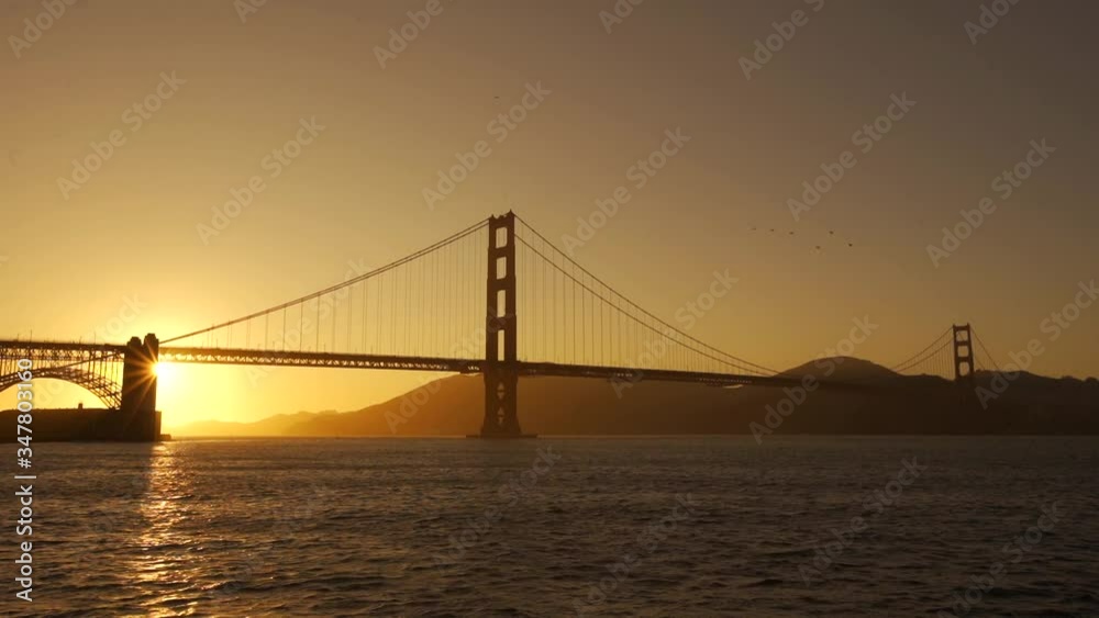 The sun setting on the bridge at dusk of the Golden Gate in San Francisco. United States The sun setting on the bridge at dusk of the Golden Gate in San Francisco. United States