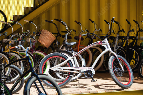 a lot of colored bikes model chopper in the city next to the yellow building in summer © Стефания Пипченко