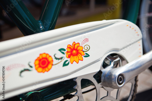 color bike with flower pattern model chopper  bicycle pedal detail chain in the city in summer © Стефания Пипченко