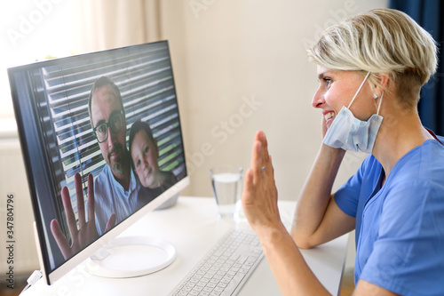 Woman doctor having video call with patients on laptop, online consultation concept. photo